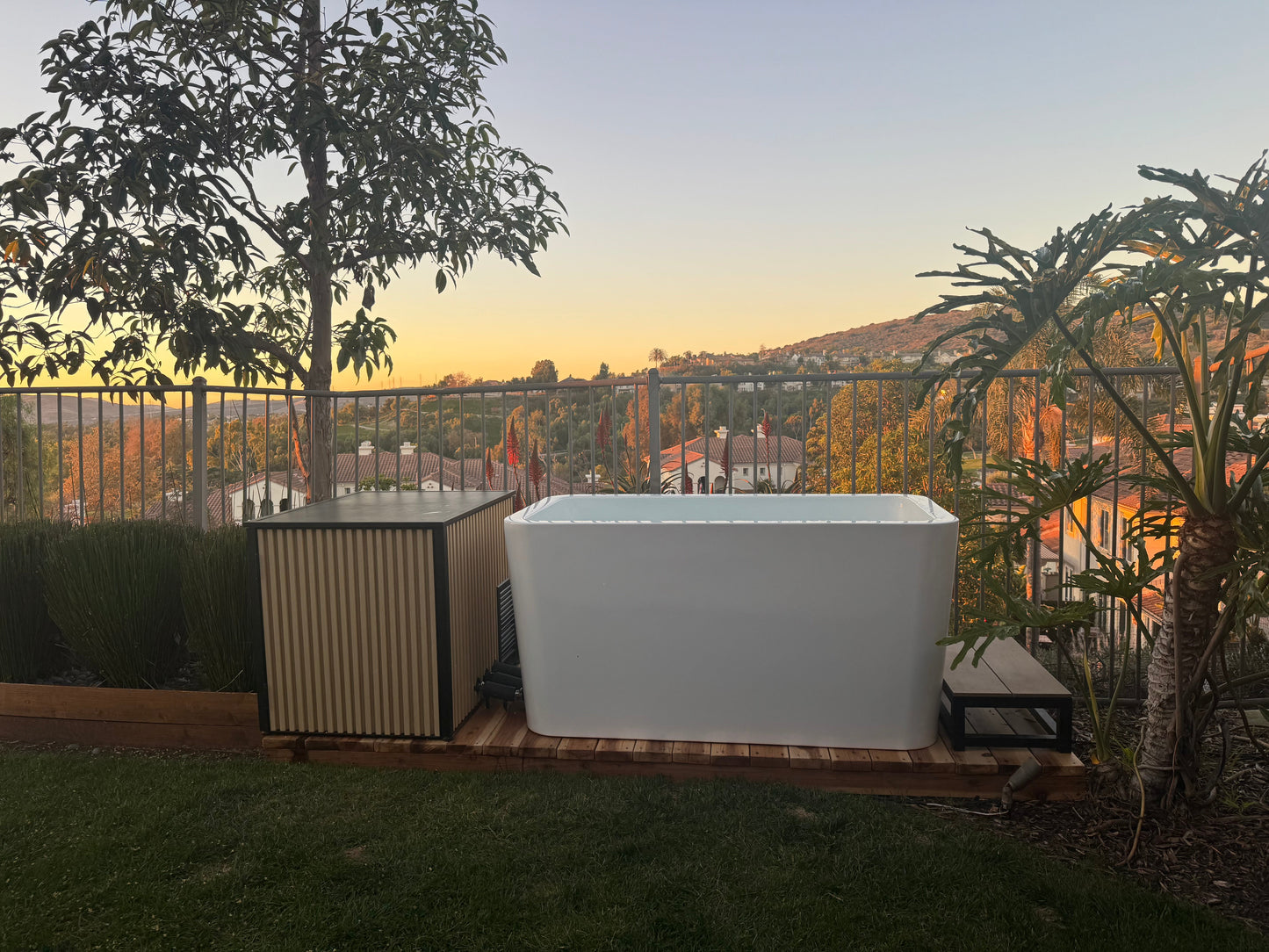 White cold plunge tub in outdoor setting