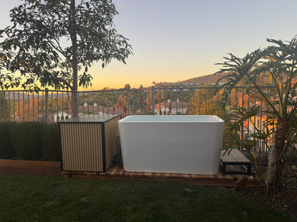White cold plunge tub in outdoor setting