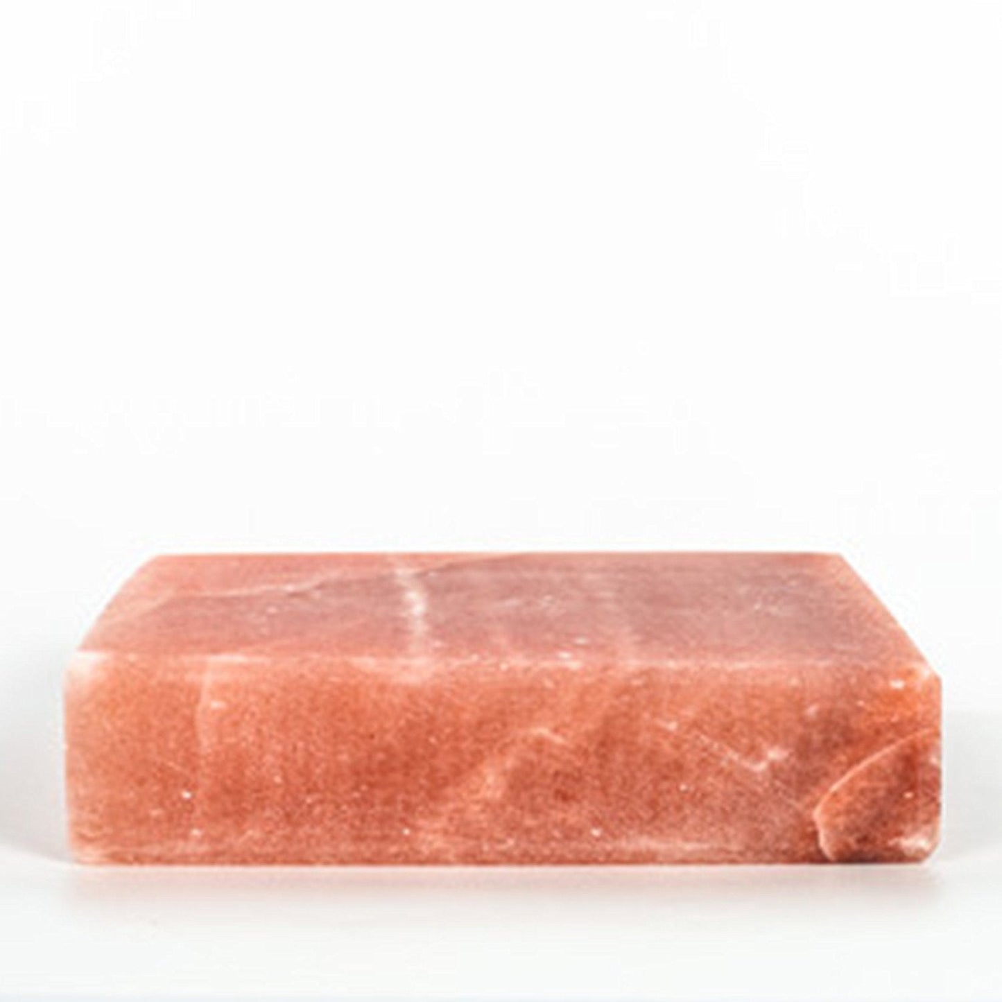 Rectangular pink himalayan salt stone on a white background