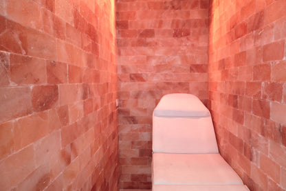 Lounge chair in a pink himalayan salt therapy room