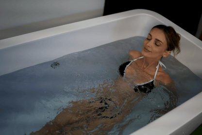 Woman in white cold plunge tub
